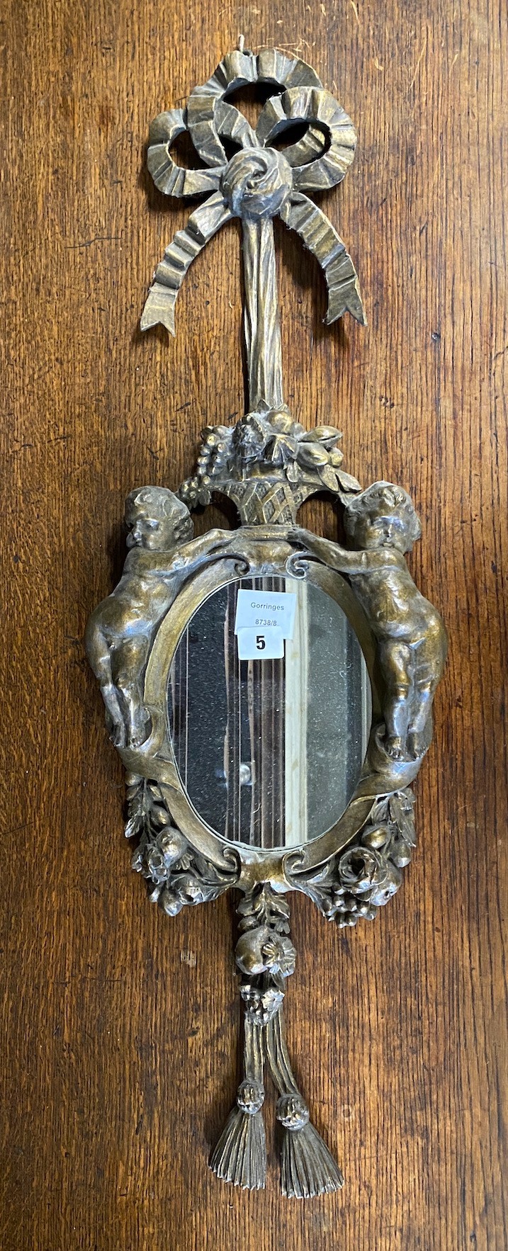 An 18th century style carved giltwood and composition cherub mirror, height 78cm